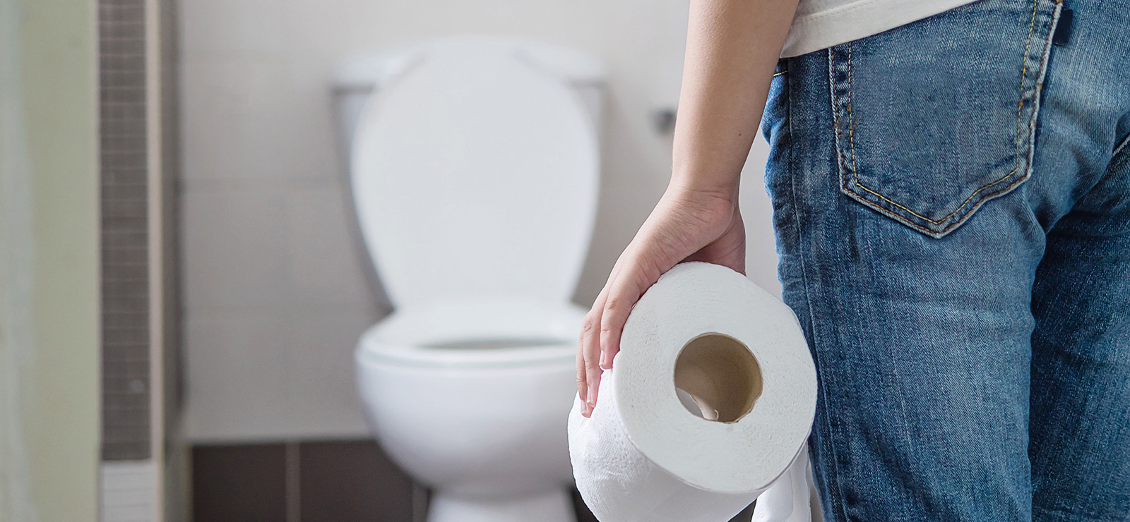 person at toilet with toilet paper