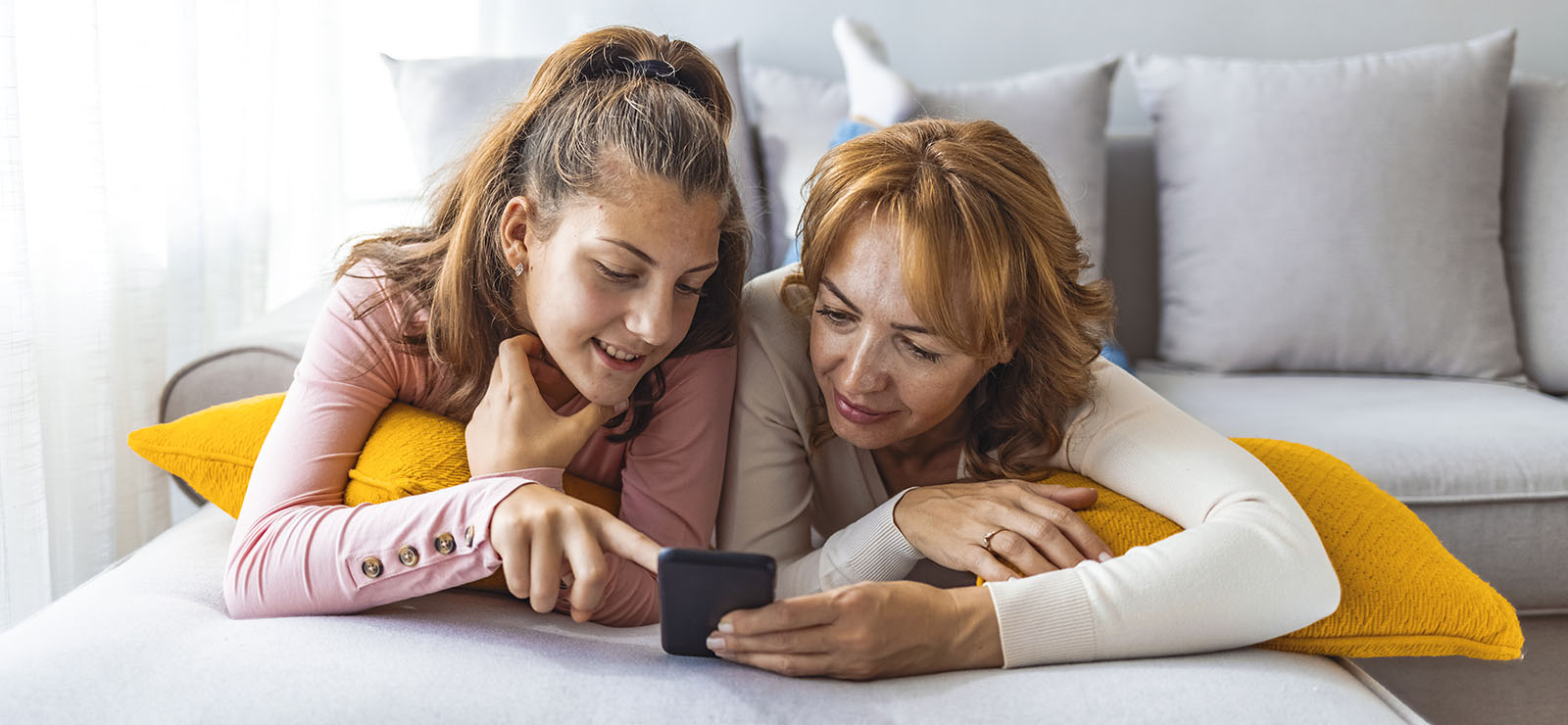 Mother and daughter looking at a phone