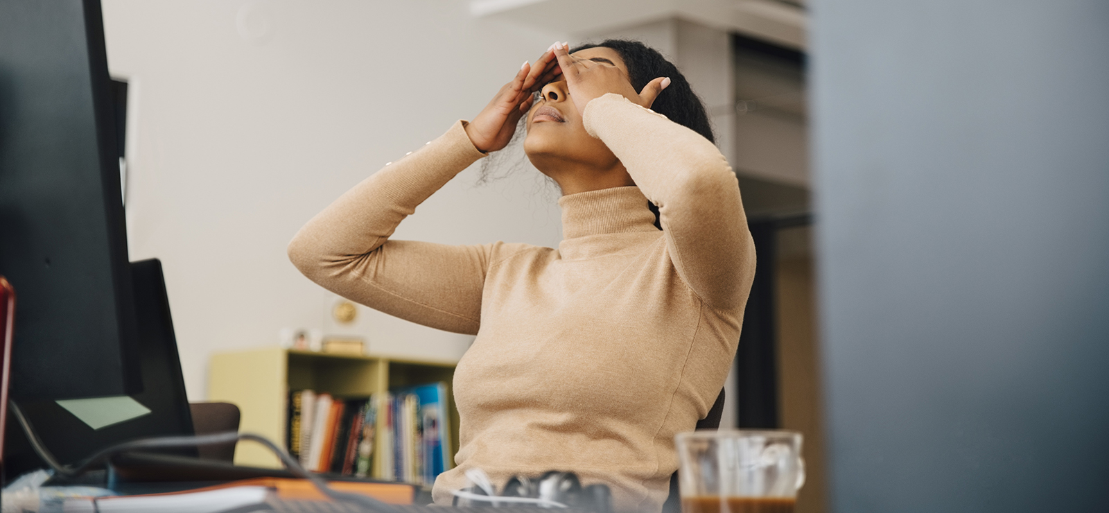 Stressed woman with her hands on her head