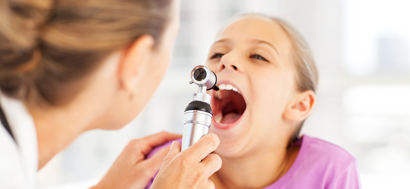 child being examined by doctor