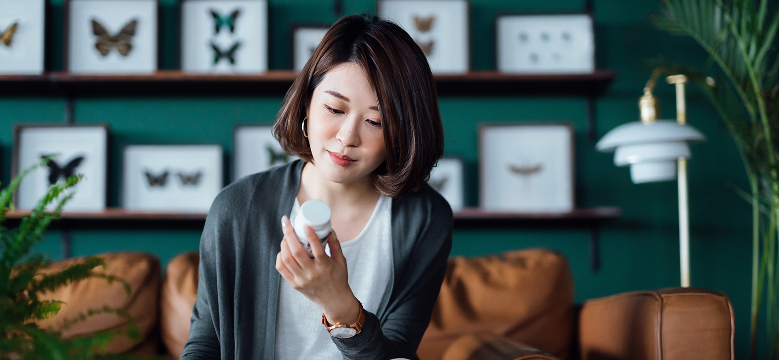 woman looking at pill bottle