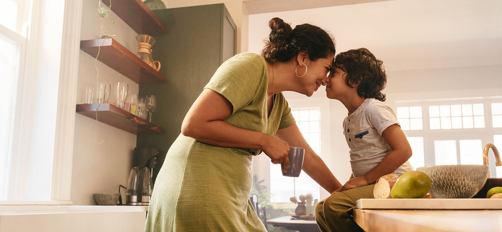 A mother and child in the kitchen.