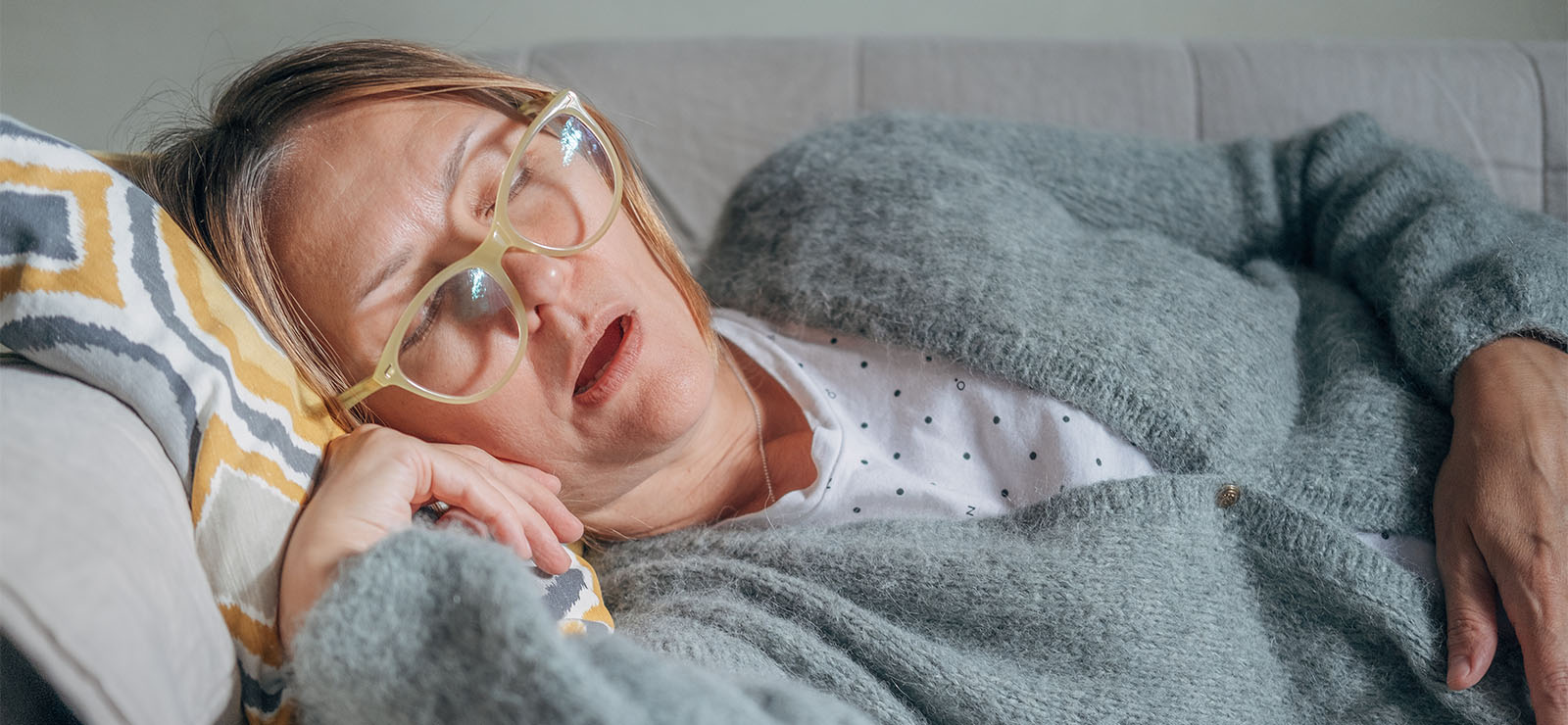 A woman asleep on the couch.