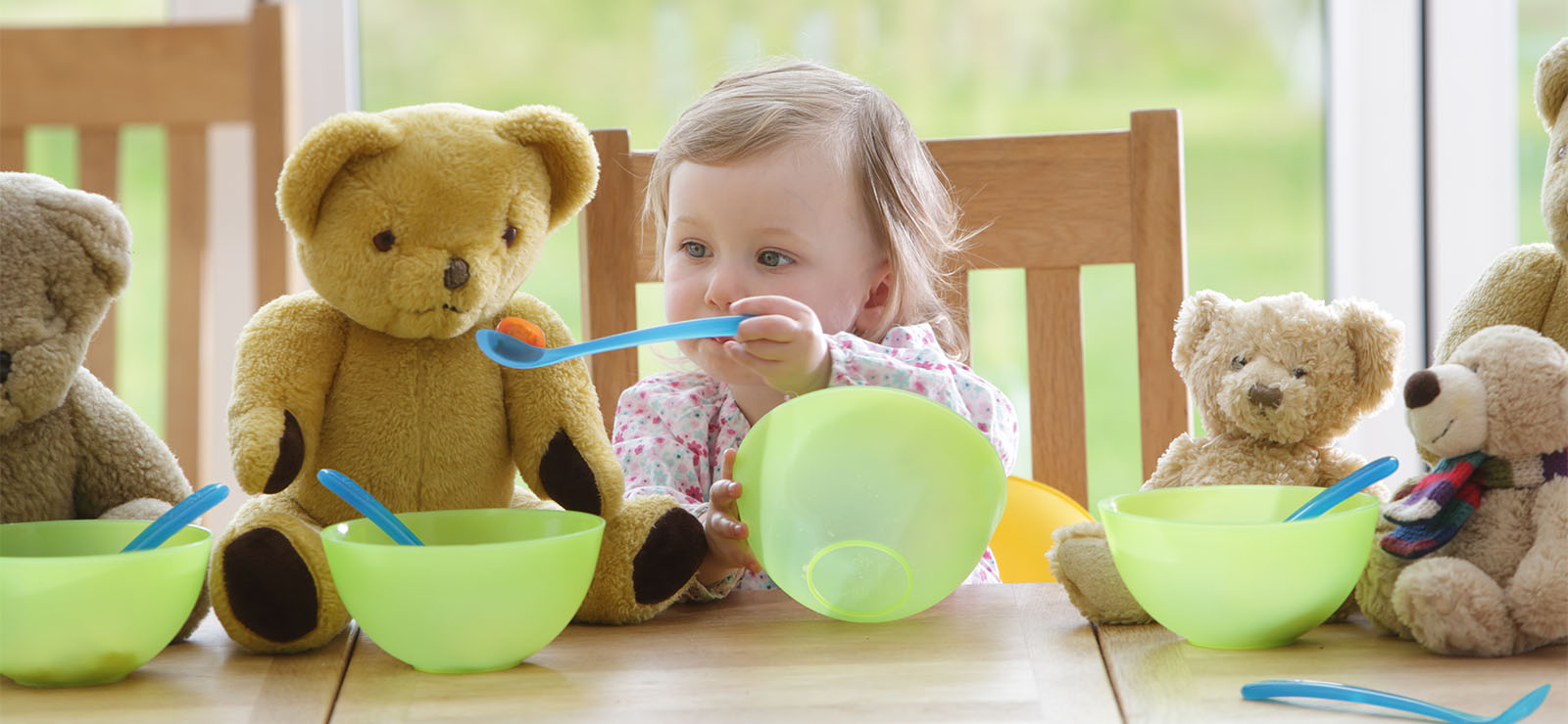 A child playing with toys at a table.