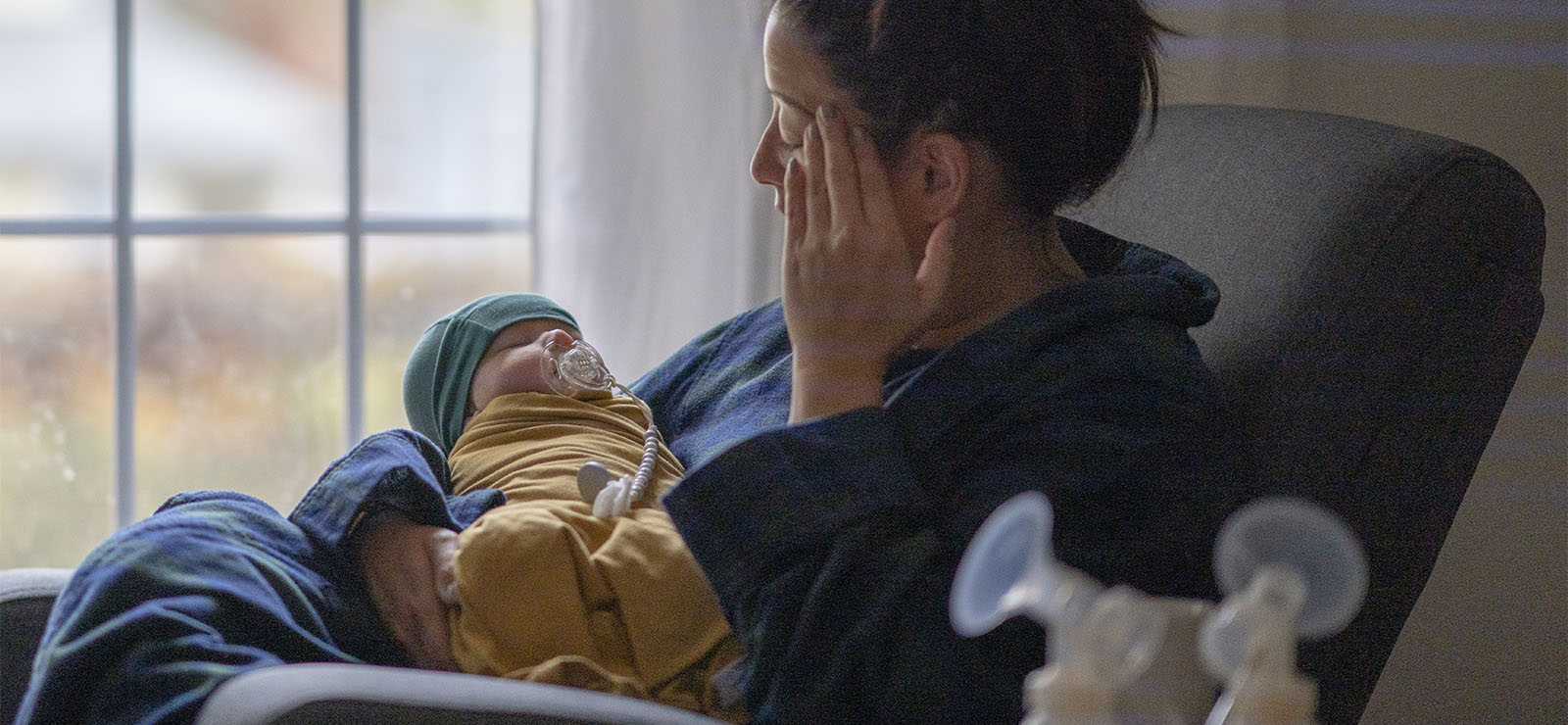 A mother holding her newborn child.