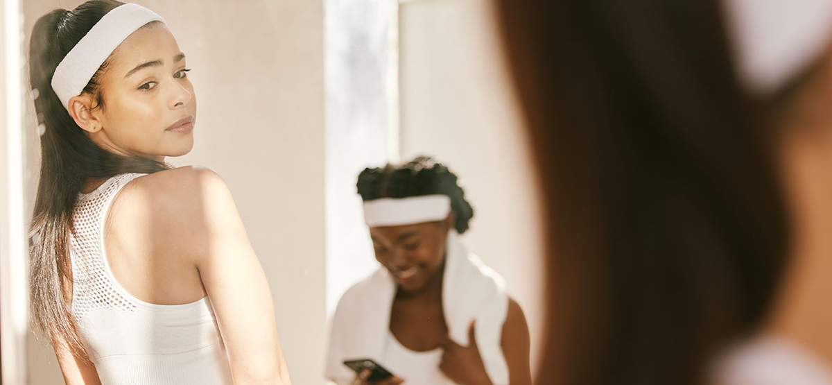 A woman look at herself in the mirror.