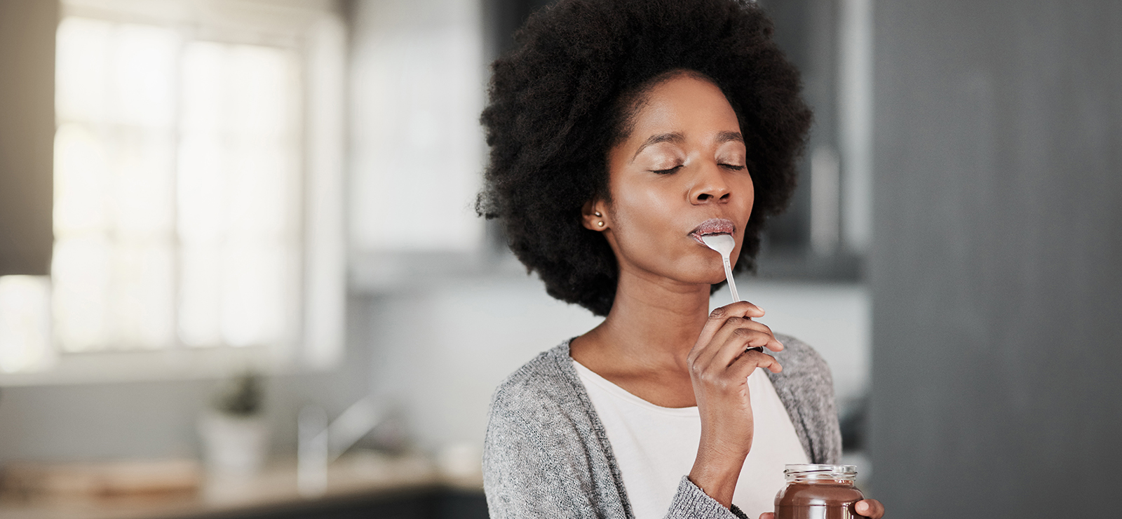 A photo of a woman eating some food.