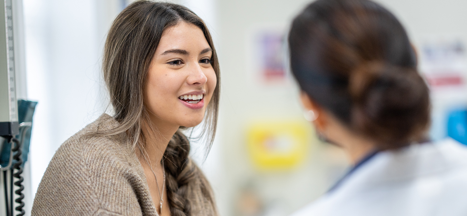 A woman talking to a primary care physician.