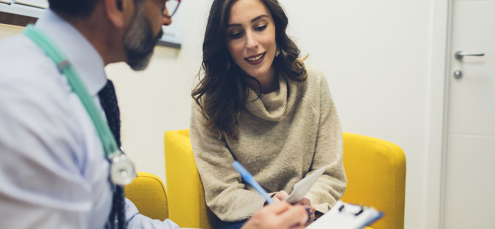 A woman speaking with a physician.