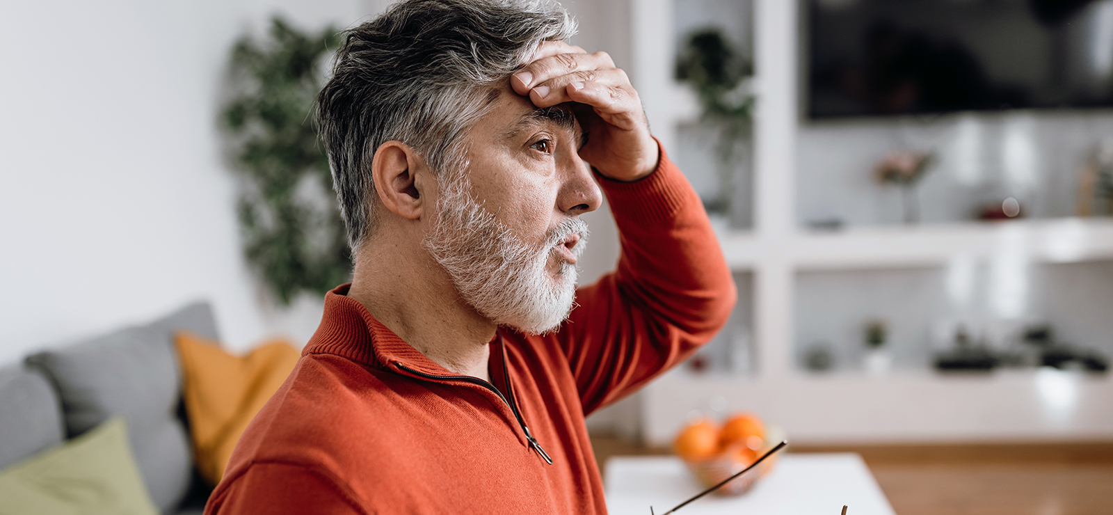 A man wiping his forehead.