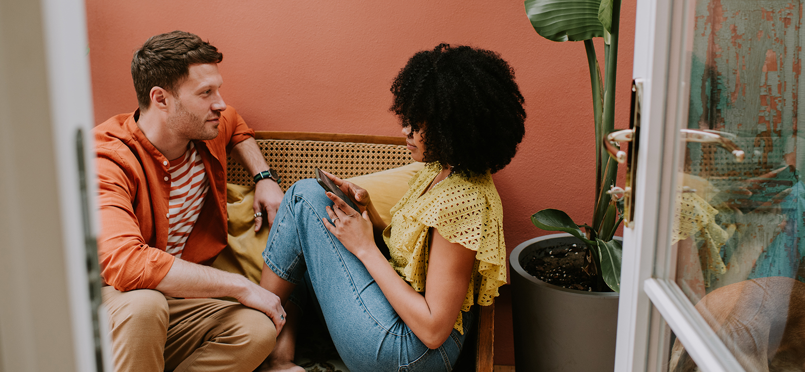 A man and a woman sitting on a sofa.