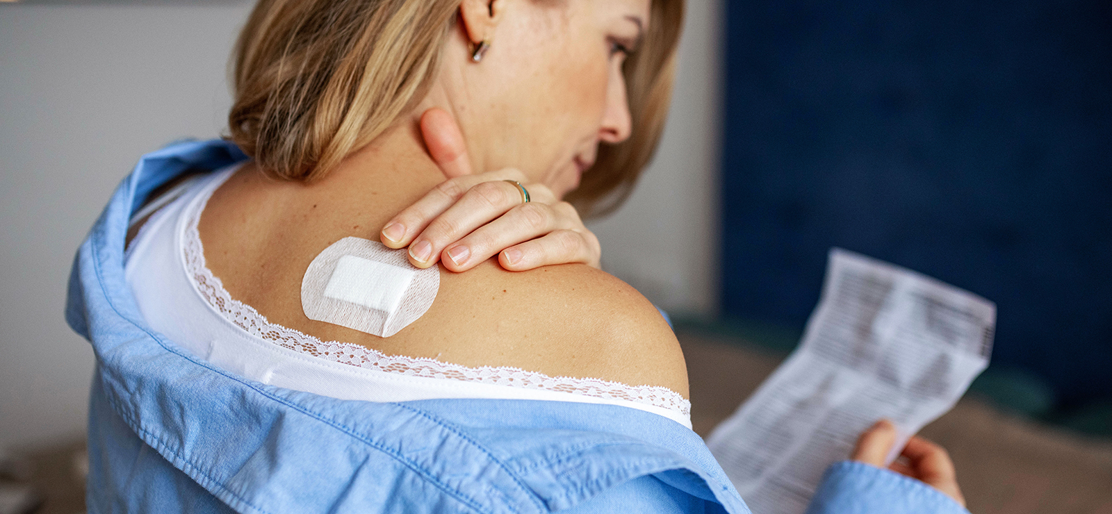 A photo of a woman reading over a prescription.