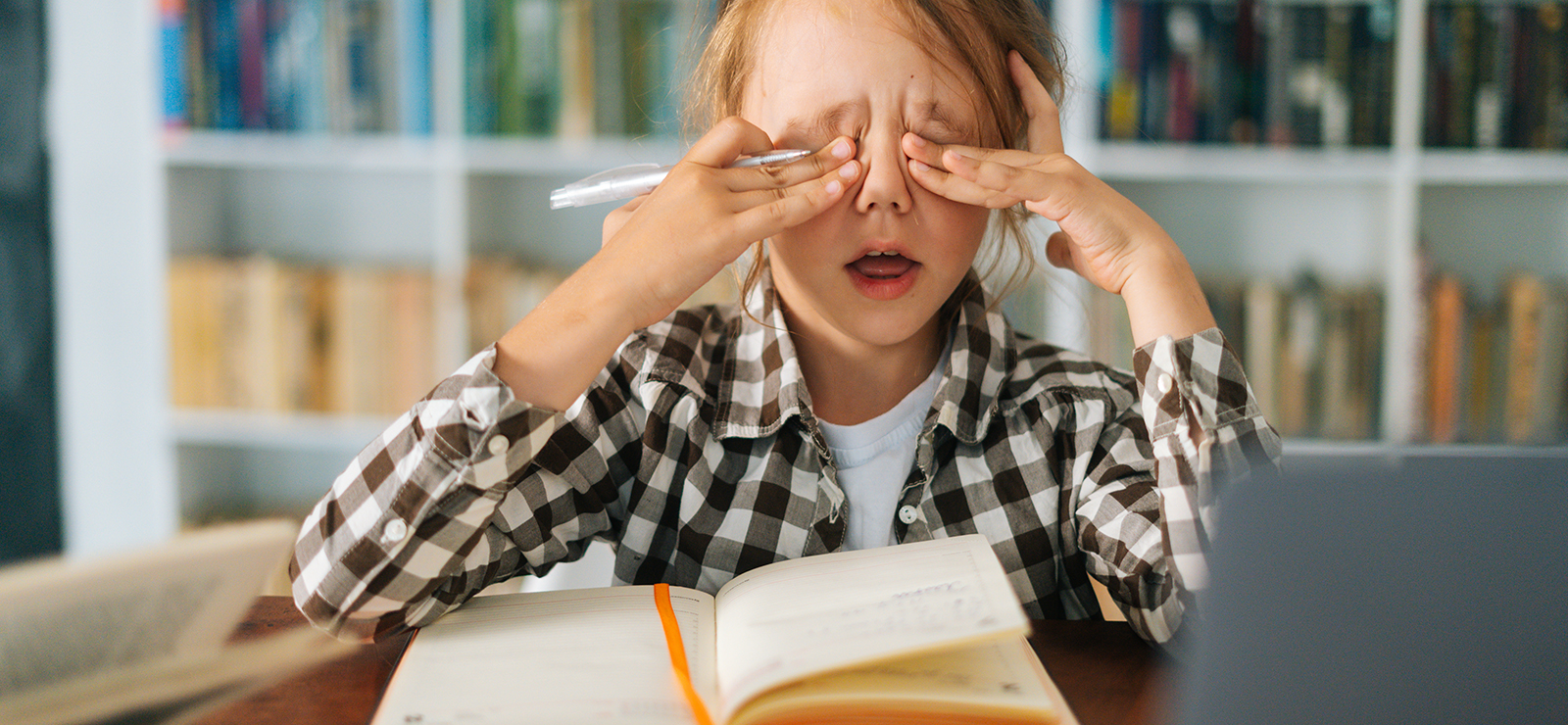 A little girl rubbing her eyes.