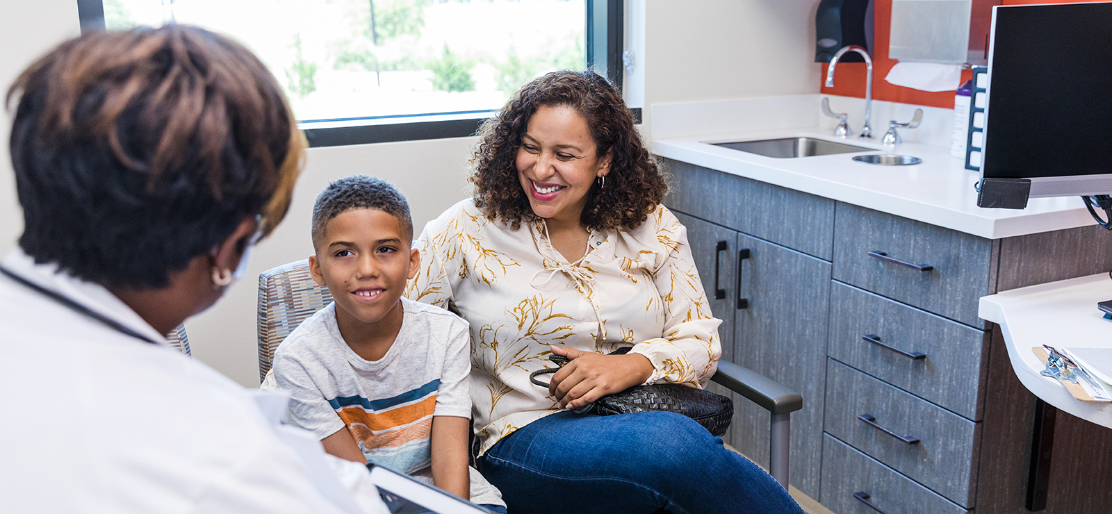 A mother and child speaking with a physician.