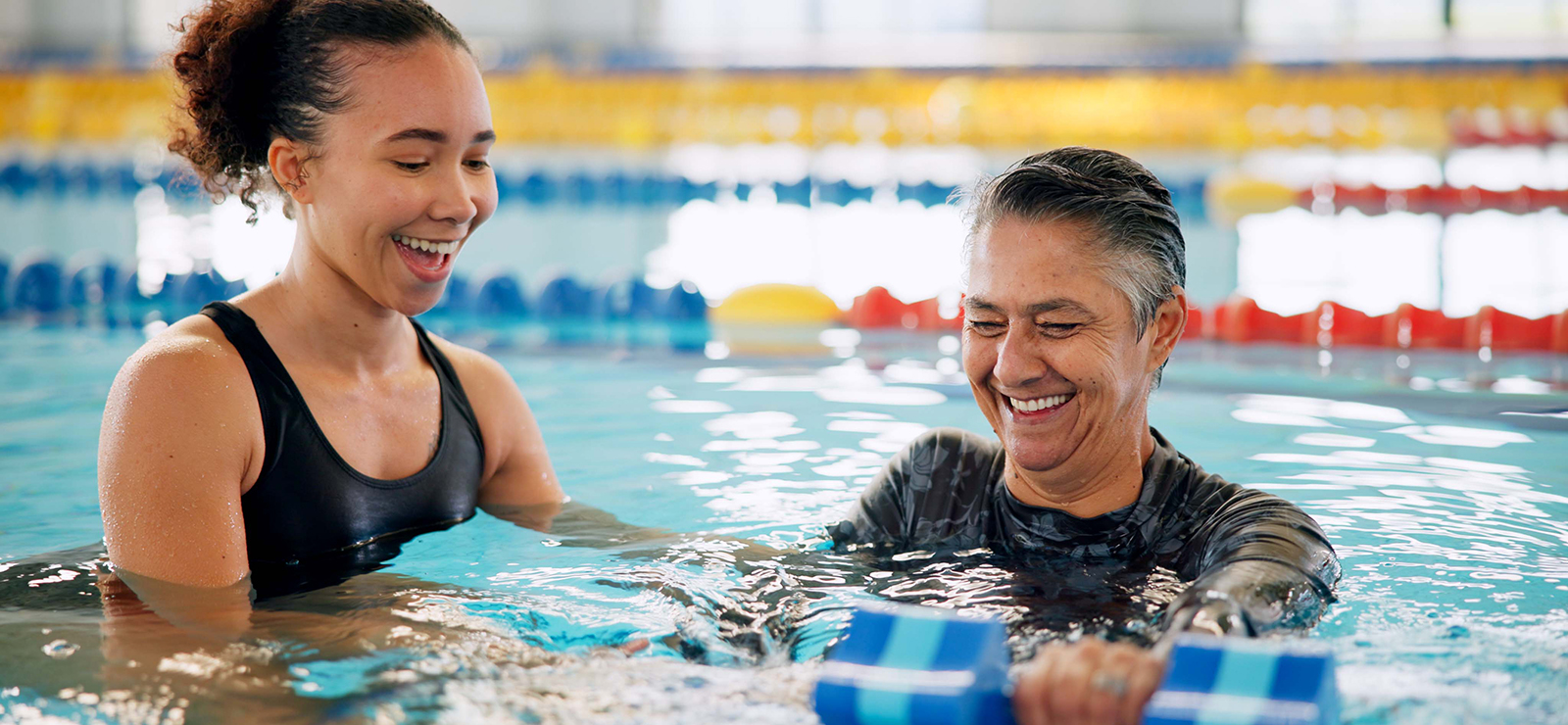 Two people in a swimming pool.