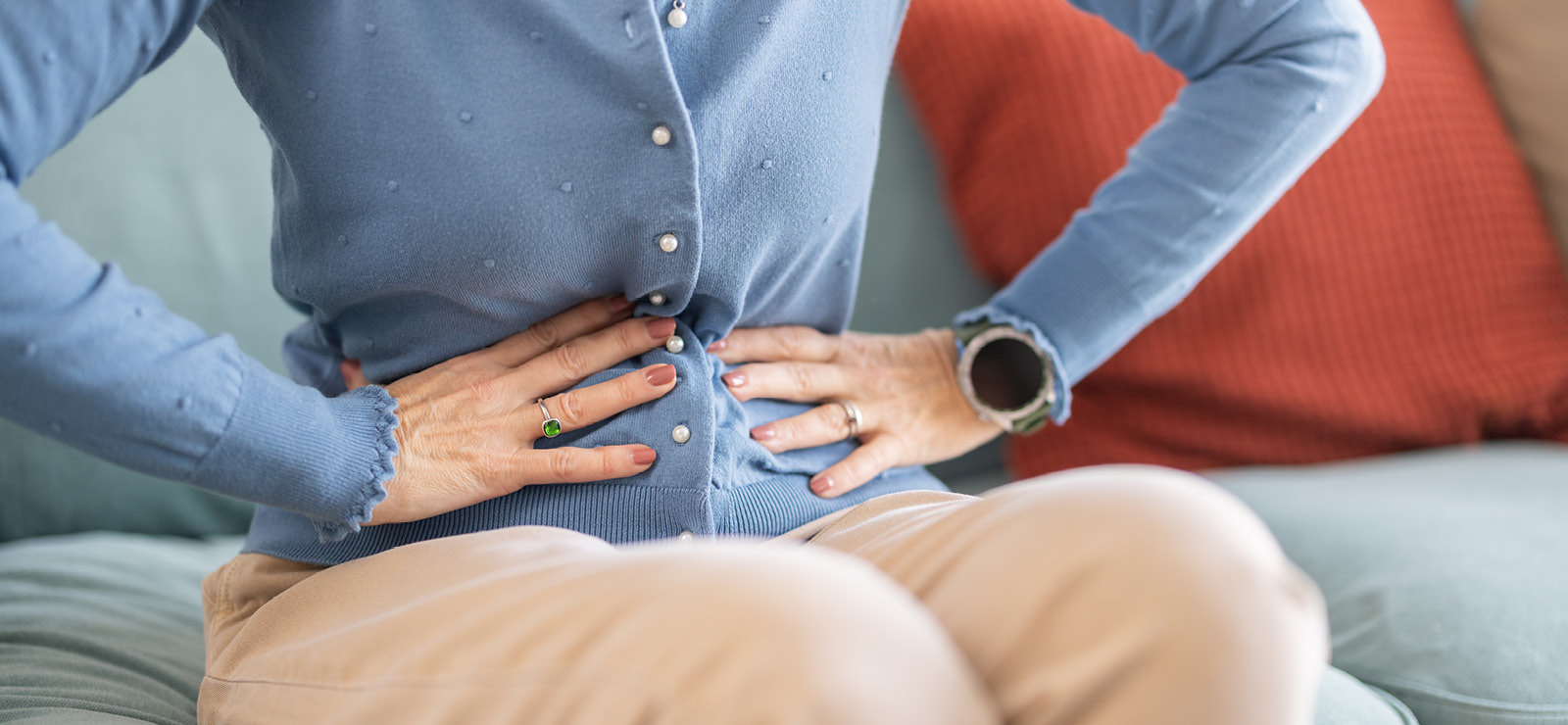 A photo of a person gripping their stomach.