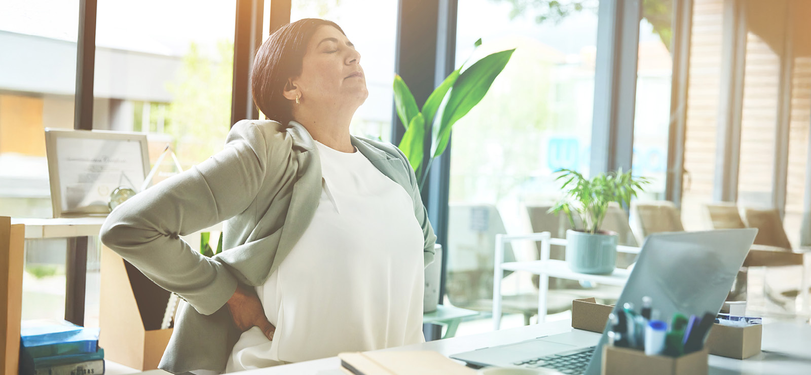 A woman rubbing her back.