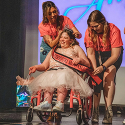 Child wins a pageant and is presented a crown.