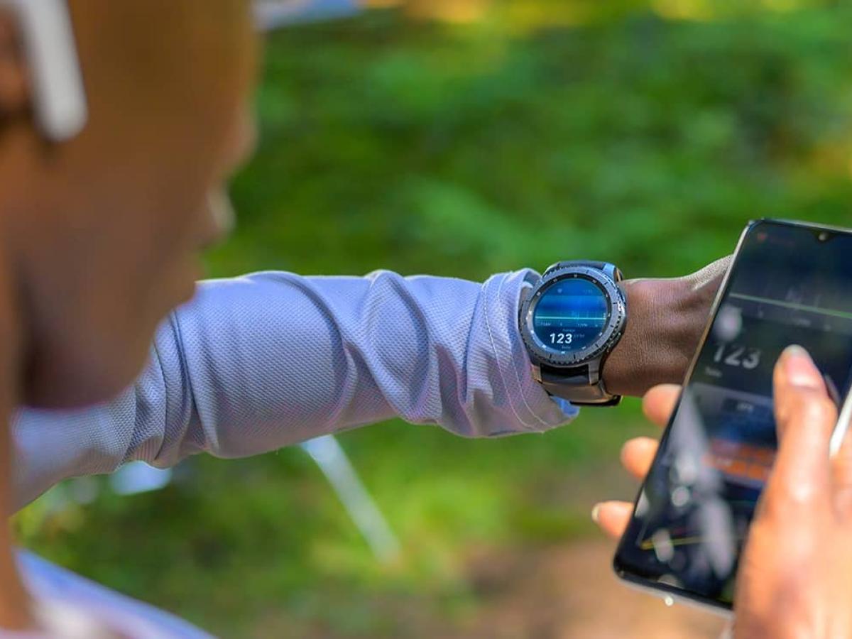 Woman looking at workout app on her phone