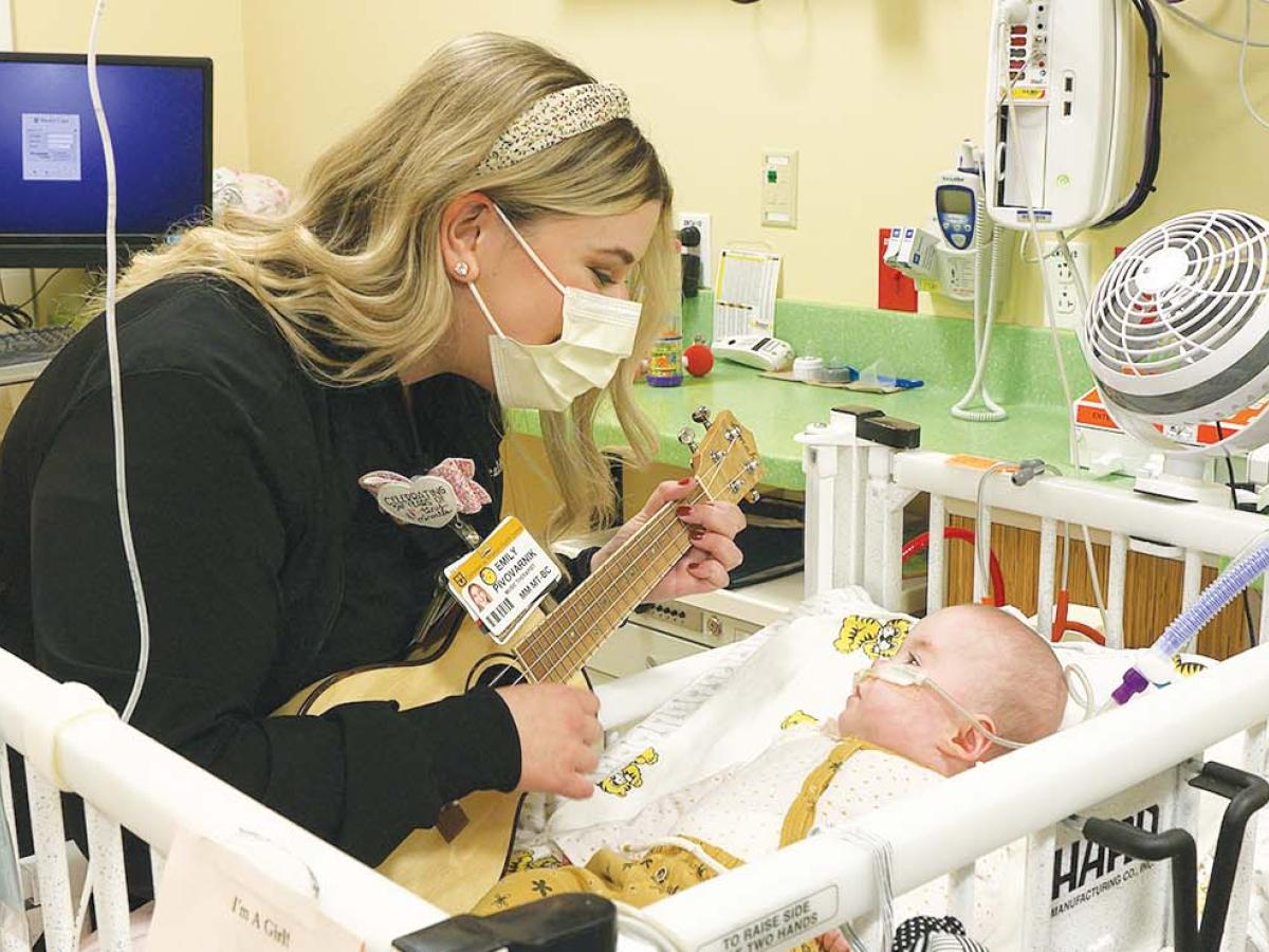 Emily Pivovarnik singing to baby