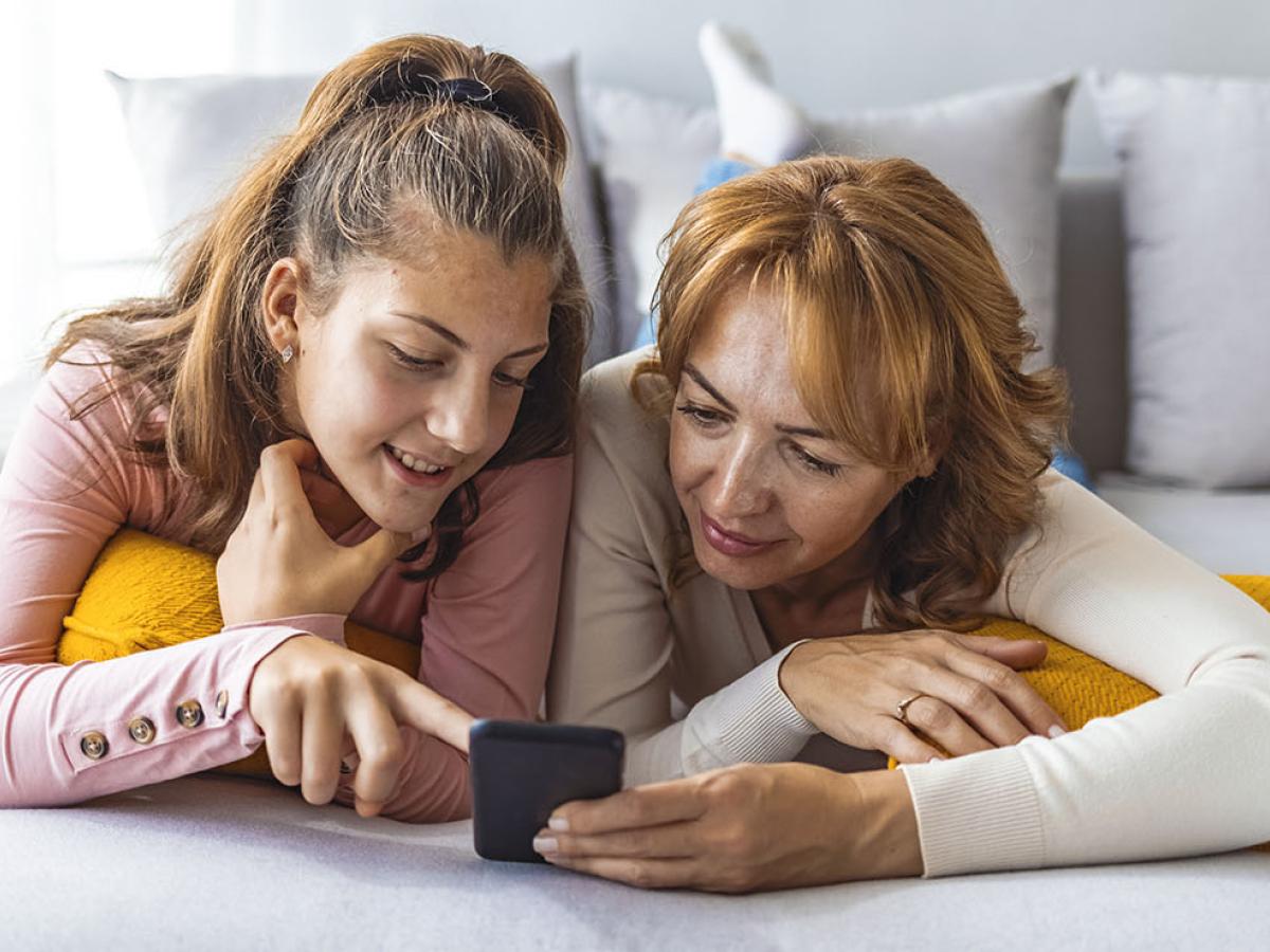 Mother and daughter looking at a phone