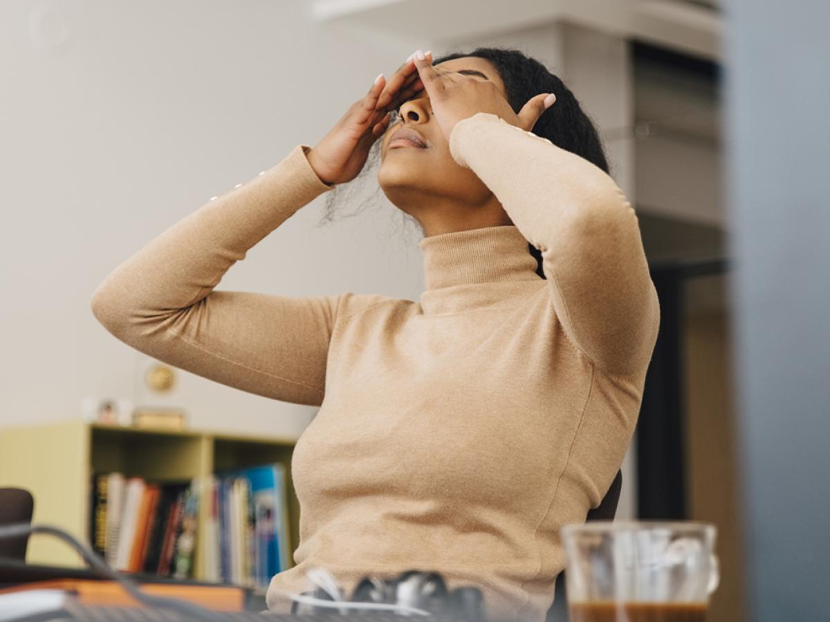 Stressed woman with her hands on her head