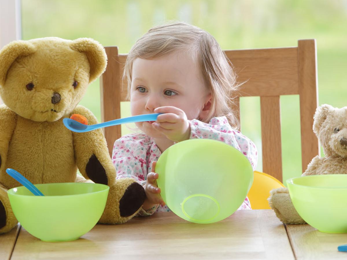 A child playing with toys at a table.