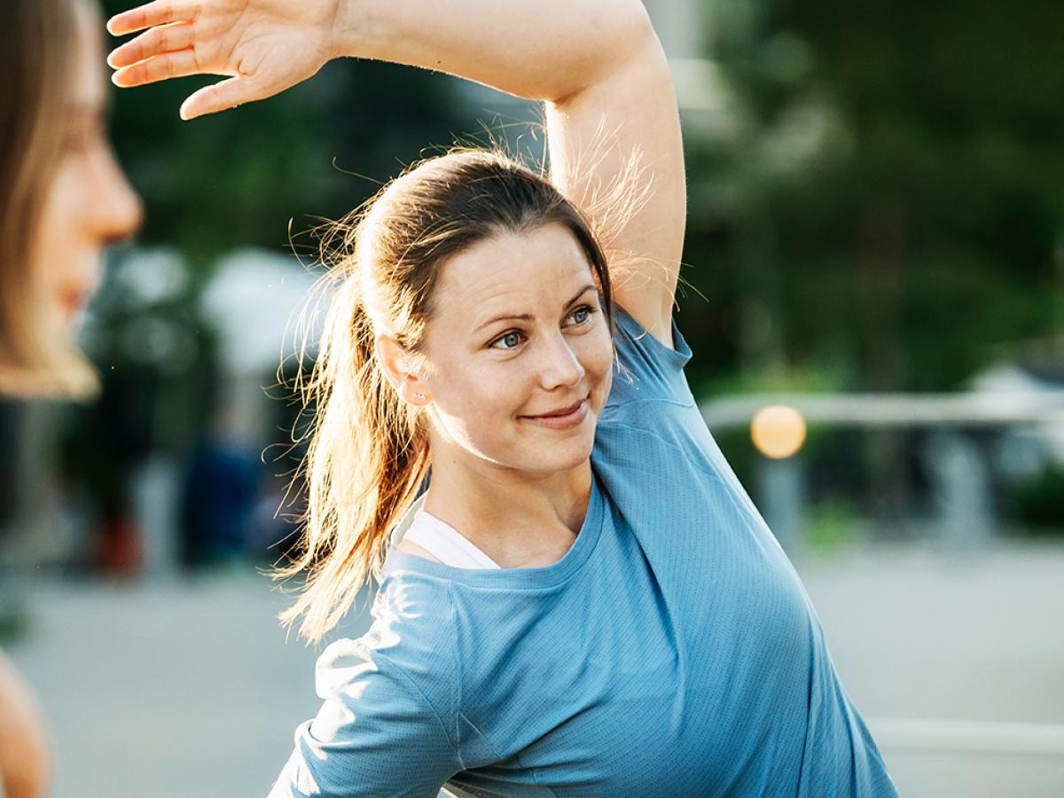 a woman stretching outdooors
