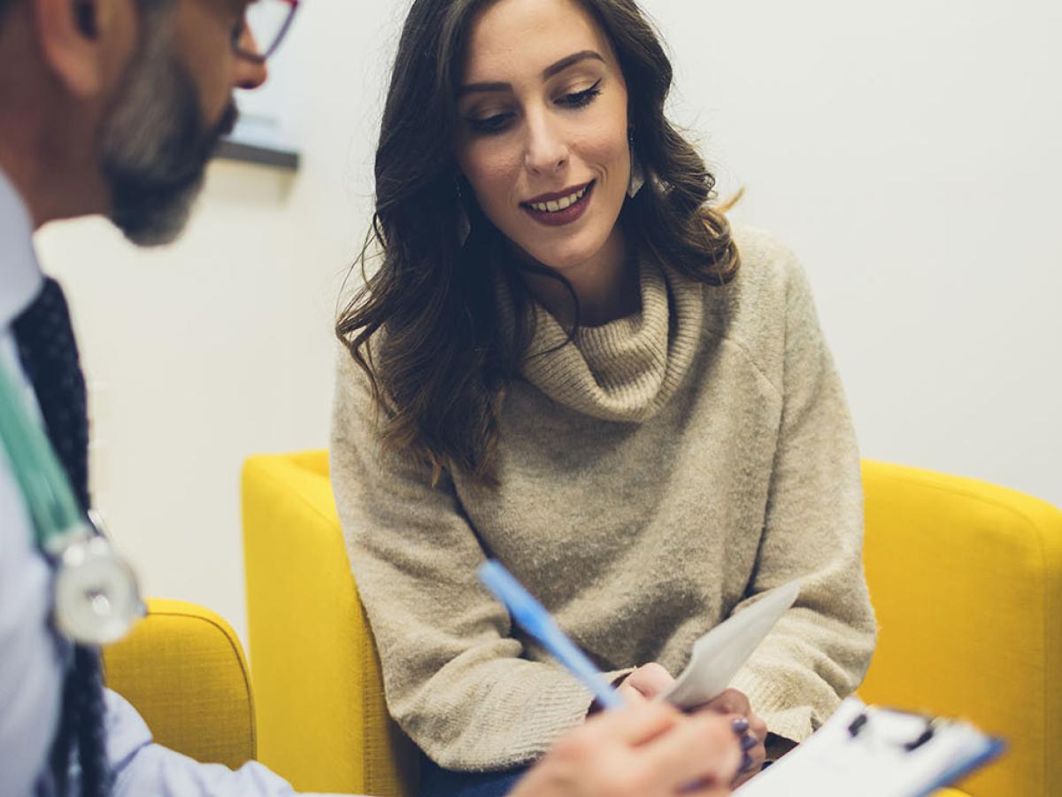 A woman speaking with a physician.