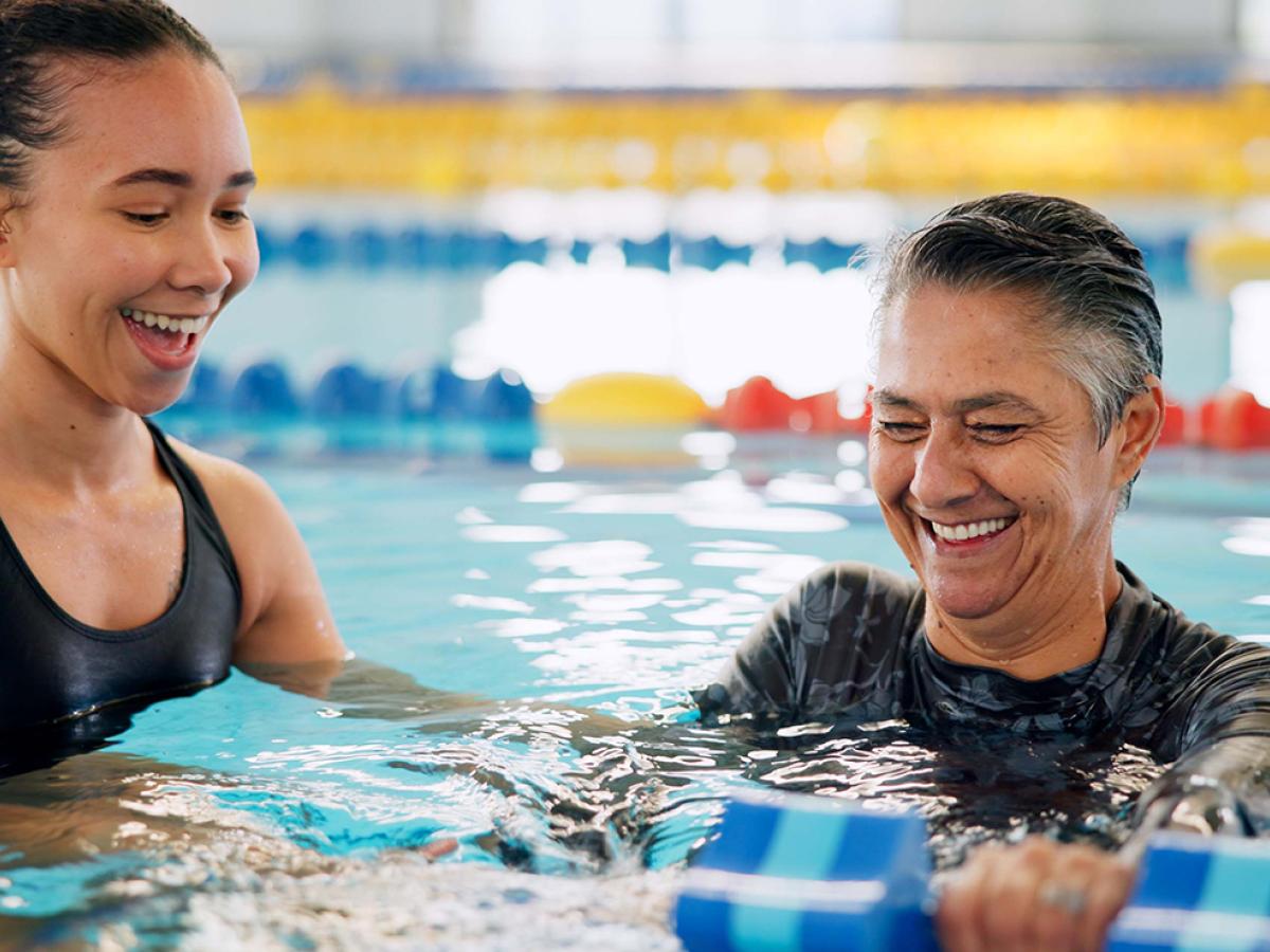 Two people in a swimming pool.