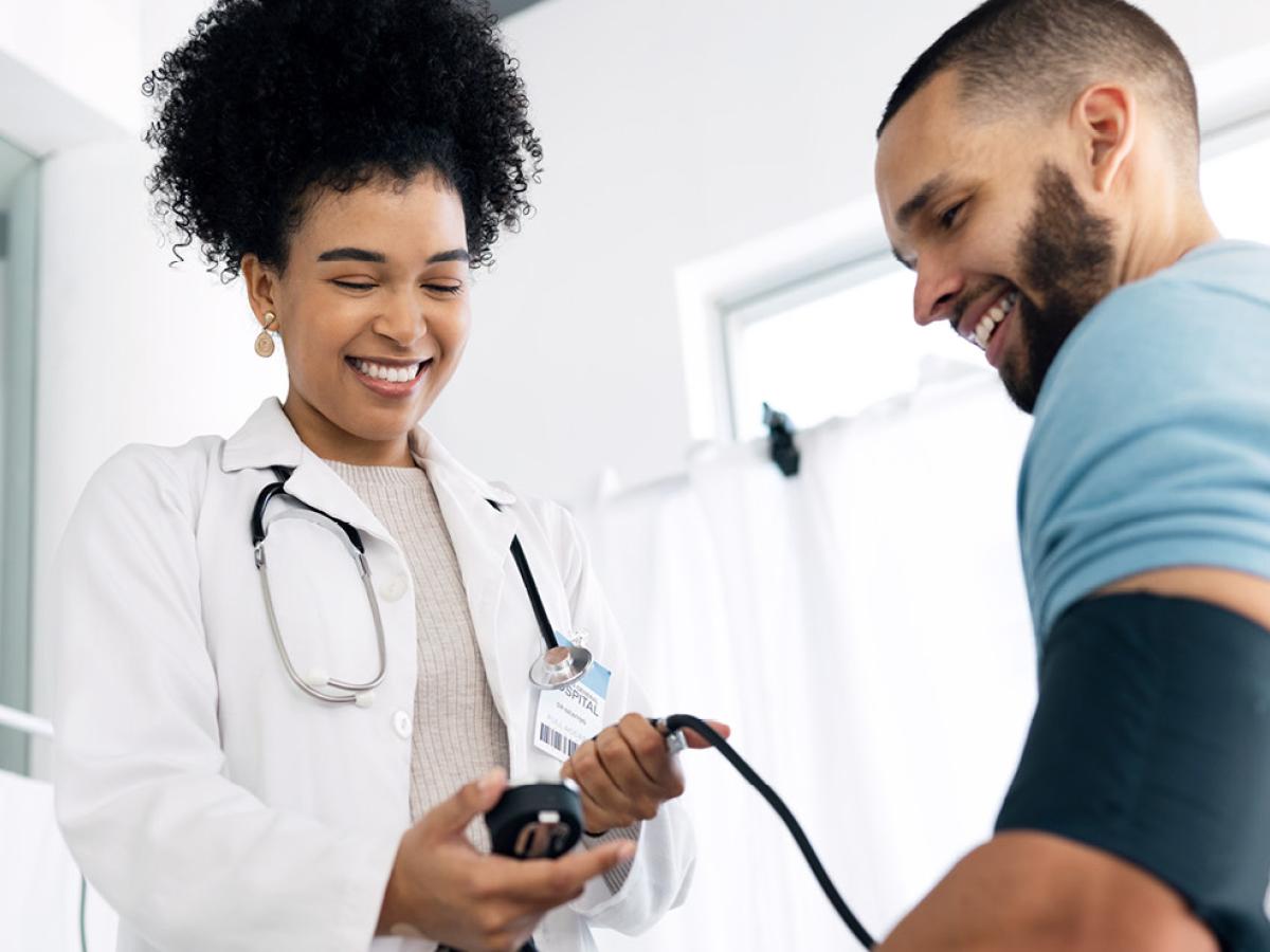 A physician taking the blood pressure of a patient