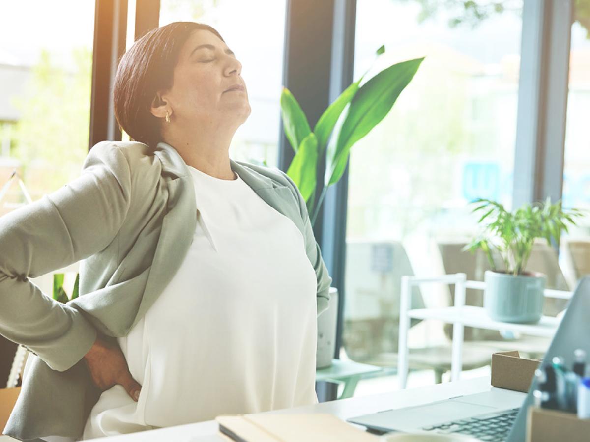 A woman rubbing her back.