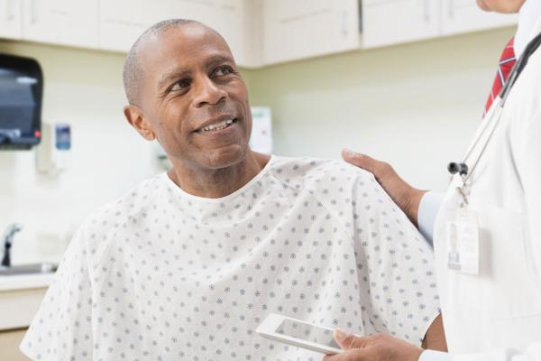 A male patient speaking with his doctor.