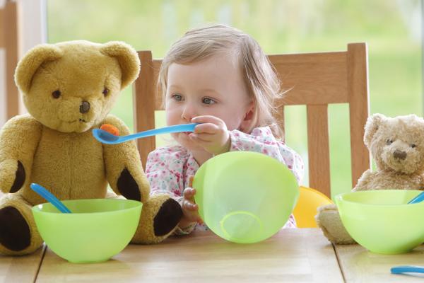 A child playing with toys at a table.