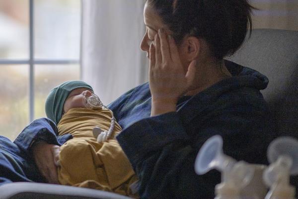 A mother holding her newborn child.