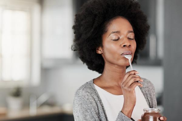 A photo of a woman eating some food.