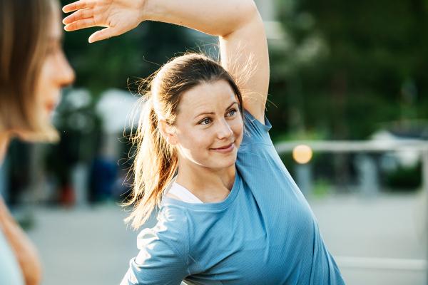 a woman stretching outdooors