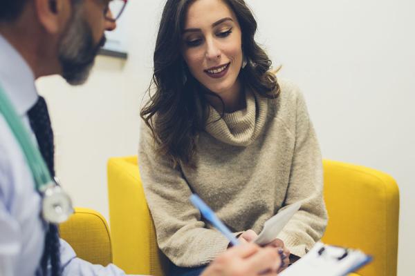A woman speaking with a physician.