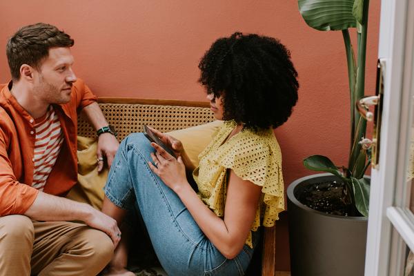A man and a woman sitting on a sofa.