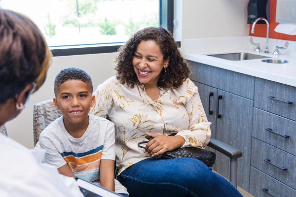 A mother and child speaking with a physician.