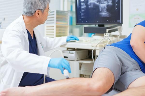 A physician using a machine to examine a patient.