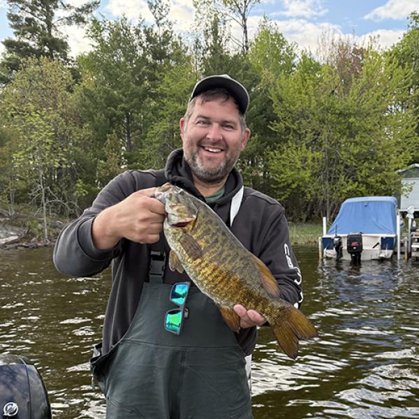 Chris Wright holding up a fish.