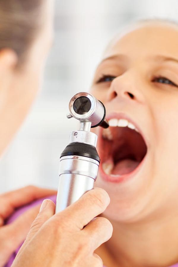 child being examined by doctor