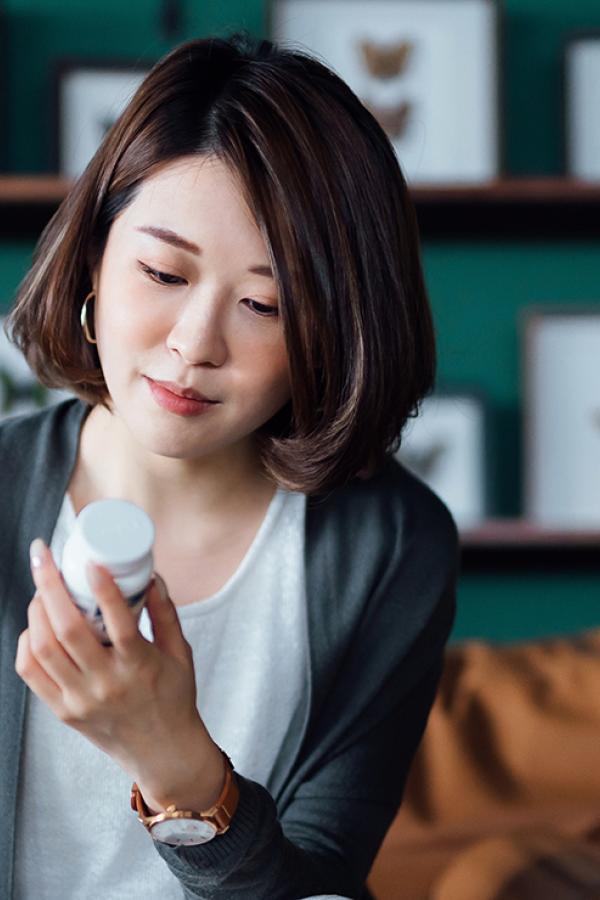 woman looking at pill bottle