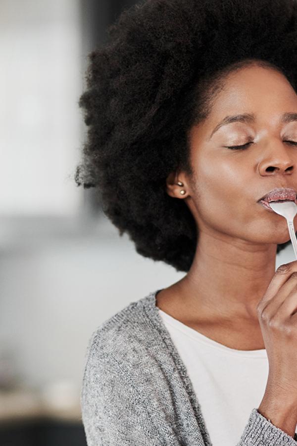A photo of a woman eating some food.