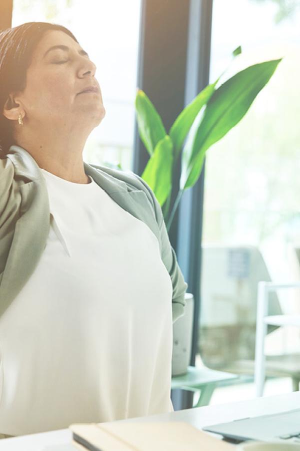 A woman rubbing her back.