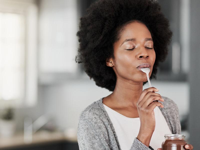 A photo of a woman eating some food.