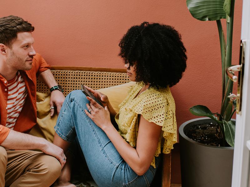 A man and a woman sitting on a sofa.