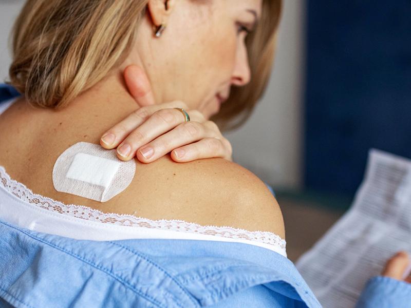 A photo of a woman reading over a prescription.