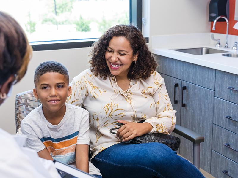 A mother and child speaking with a physician.